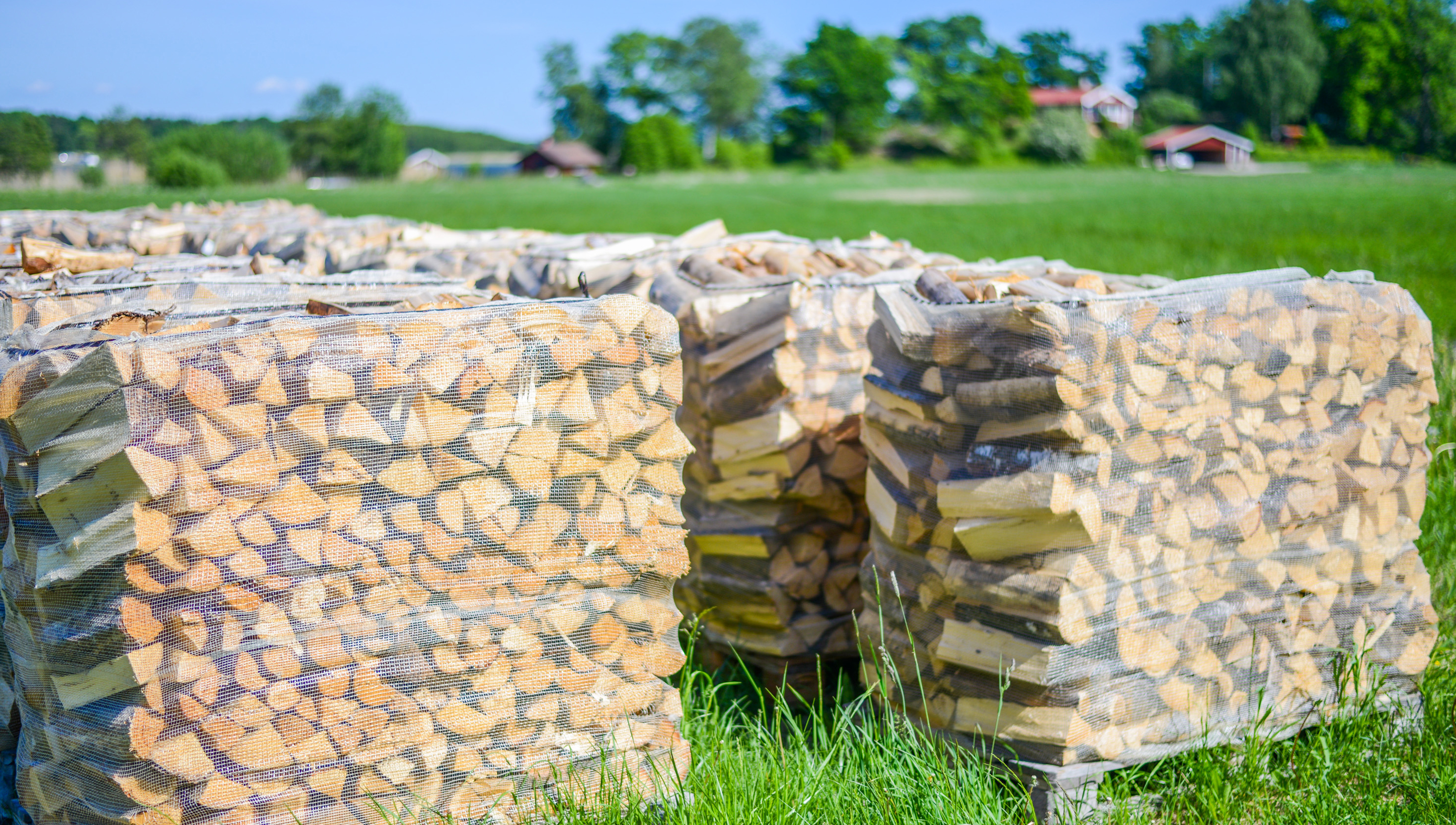 Overview of piles of firewood for sale